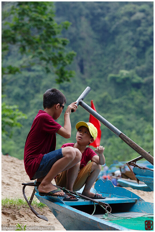 Kids playing on river boat near the Phong Nha cave entrance, Viet Nam
