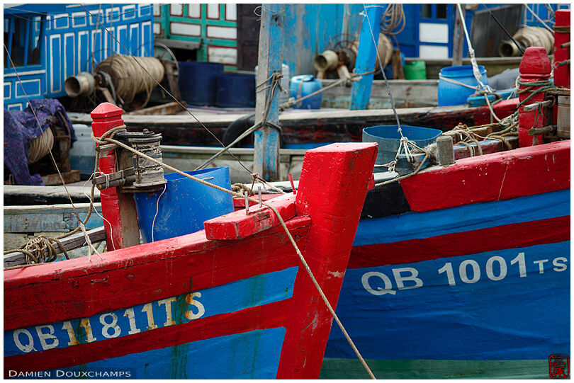 Colorful blue and red fishing boats in Dong Hoi harbour, Viet Nam
