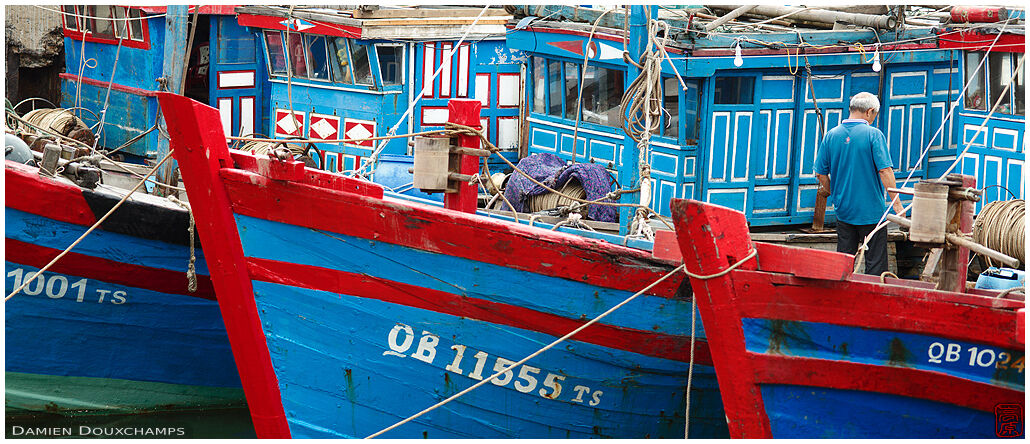 Traditional blue and red boats in Dong Hoi harbour, Viet Nam