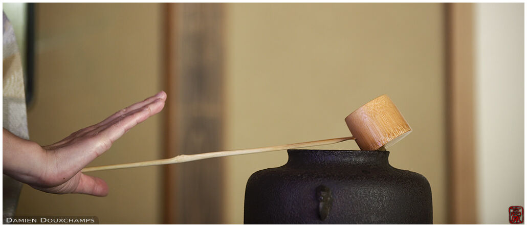 Bamboo ladle being laid on water pot during tea ceremony in Enko-ji temple, Kyoto, Japan
