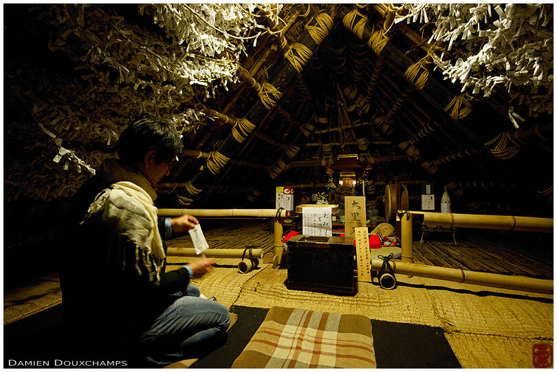 Small shrine hidden in the thatched roof structure of the Kyorinbo, Shiga, Japan