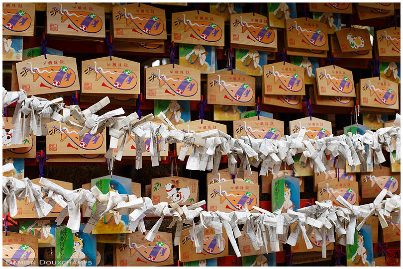 Ema tablets and discarded fortunes in Shirakumo shrine, Kyoto, Japan