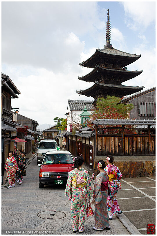Taxi passing in front of Hokanji temple's pagoda, Kyoto, Japan