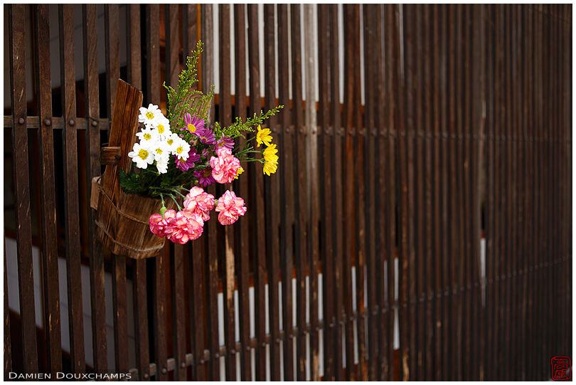 Flowers hung to traditional wooden lattice façade, Tsumago, Japan