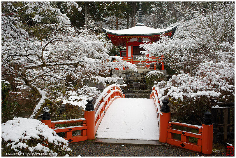 Snowy day on Daigo-ji temple Bentendo pavilion and its red bridge, Kyoto, Japan
