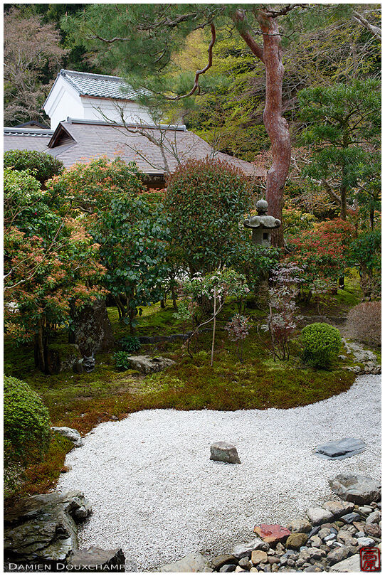 Simple dry landscape garden with kura stone house in the background, Nison-in temple, Kyoto, Japan