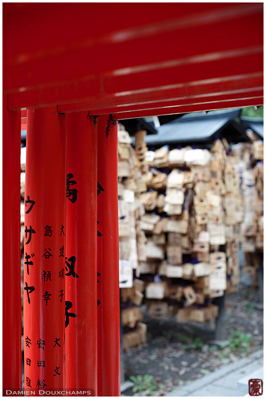 Red torii gates and ema tablets, Kitano Tenmangu shrine, Kyoto, Japan