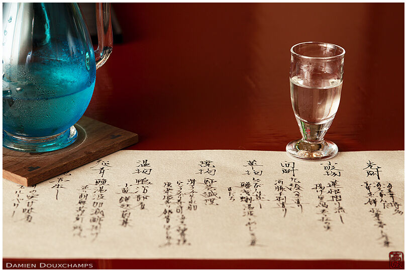 Parchment detailing the course menu of the day with sake glass in Tawaraya ryokan, Kyoto, Japan