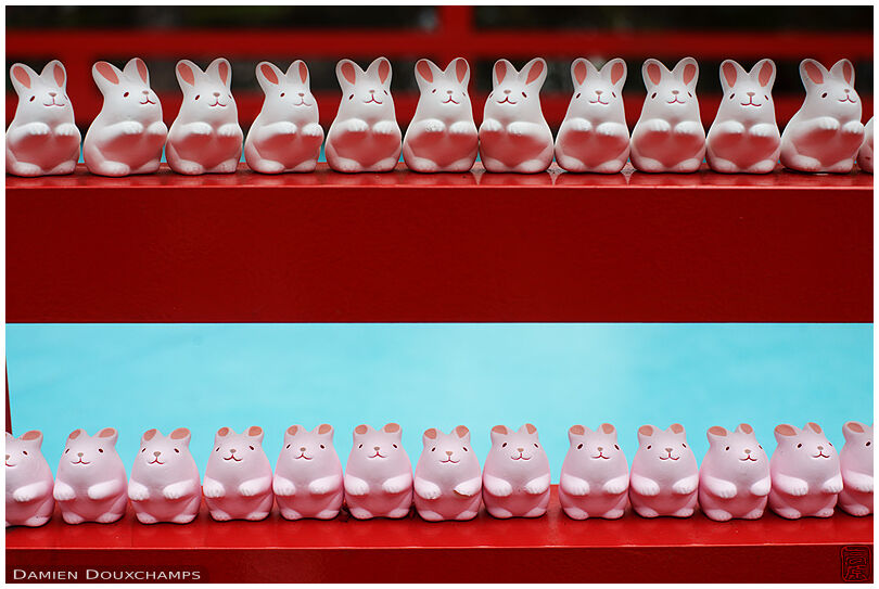 Neatly arranged rows of rabbit porcelain votive offerings in Okazaki shrine, Kyoto, Japan