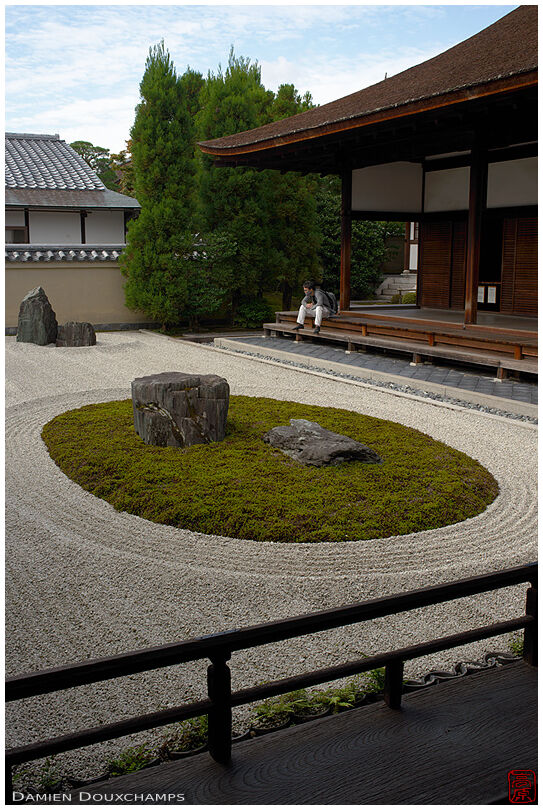 Man resting on the side of Ryogen-in dry landscape garden, Kyoto, Japan