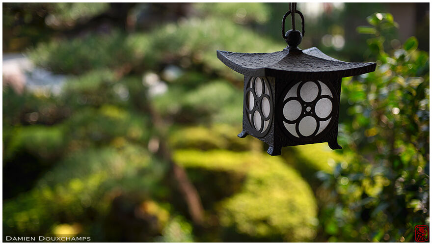 Small cute metallic lantern with round patterns in Shobo-ji temple gardens, Kyoto, Japan