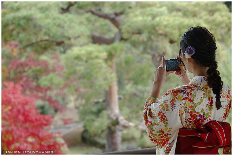 Kimono wearing lady taking pictures in Shodensan-so, Kyoto, Japan