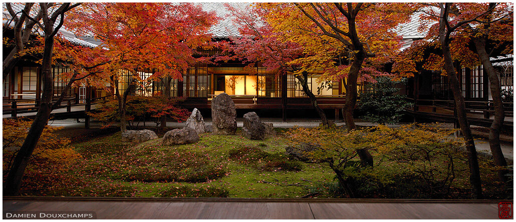 Golden light in hall behind inner moss and rock garden of Kennnin-ji temple in autumn, Kyoto, Japan