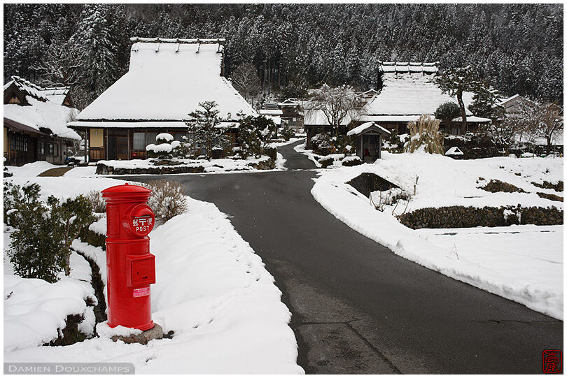 Old traditional red cylindrical mail box in Miyama village, Kyoto, Japan