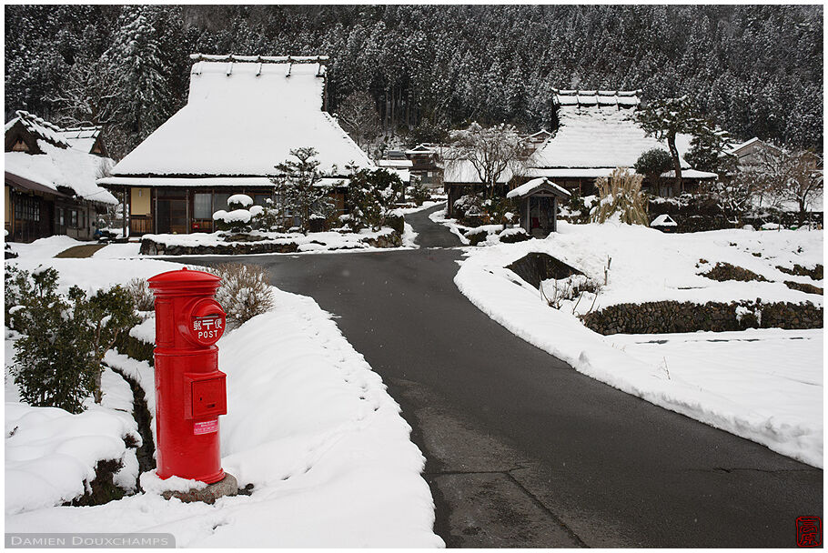 Old traditional red cylindrical mail box in Miyama village, Kyoto, Japan