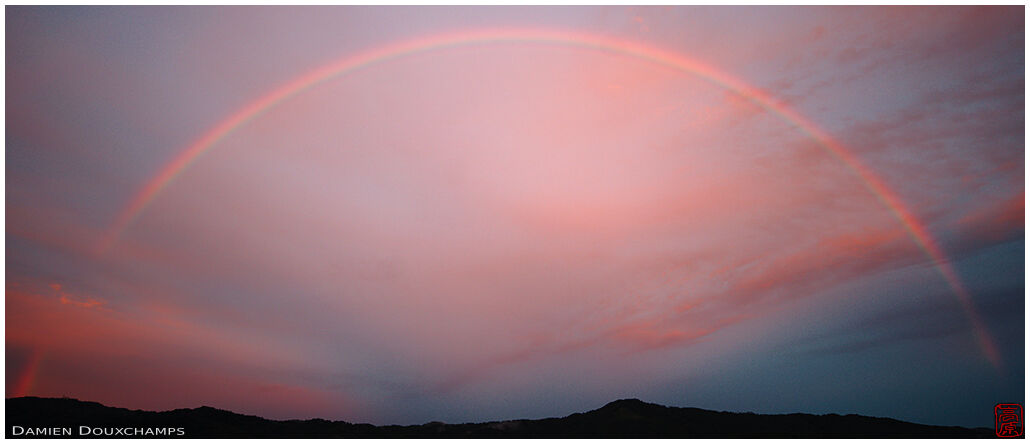 Rainbow and pink sunset sky over Kyoto, Japan