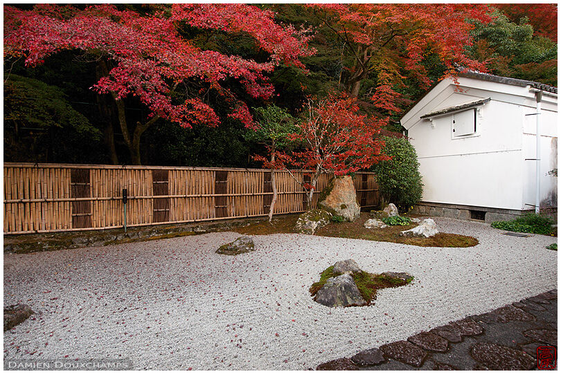 Autumn colours over rock garden near a kura storehouse of Nanzen-ji temple, Kyoto, Japan