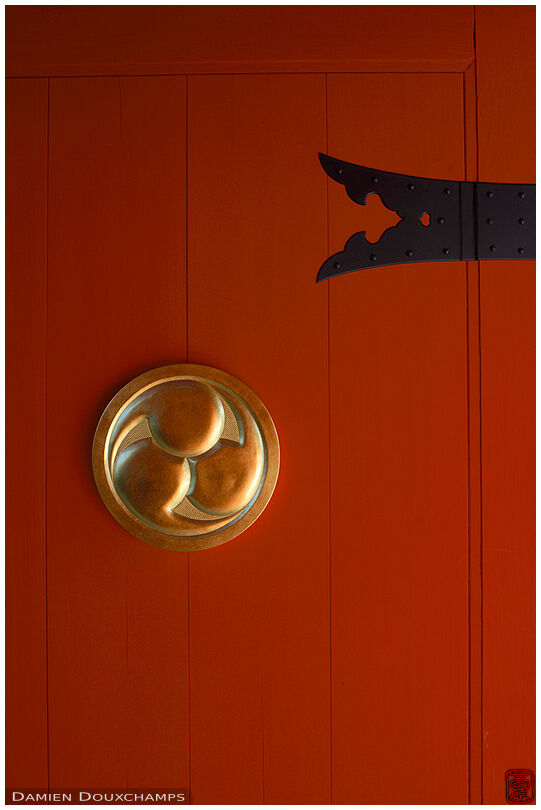 Golden medallion on the red door of Eisho-in temple, Kyoto, Japan