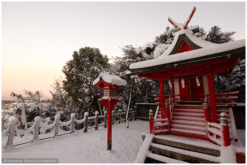Early-morning snow-covered small shrine in Yoshida-jinja, Kyoto, Japan