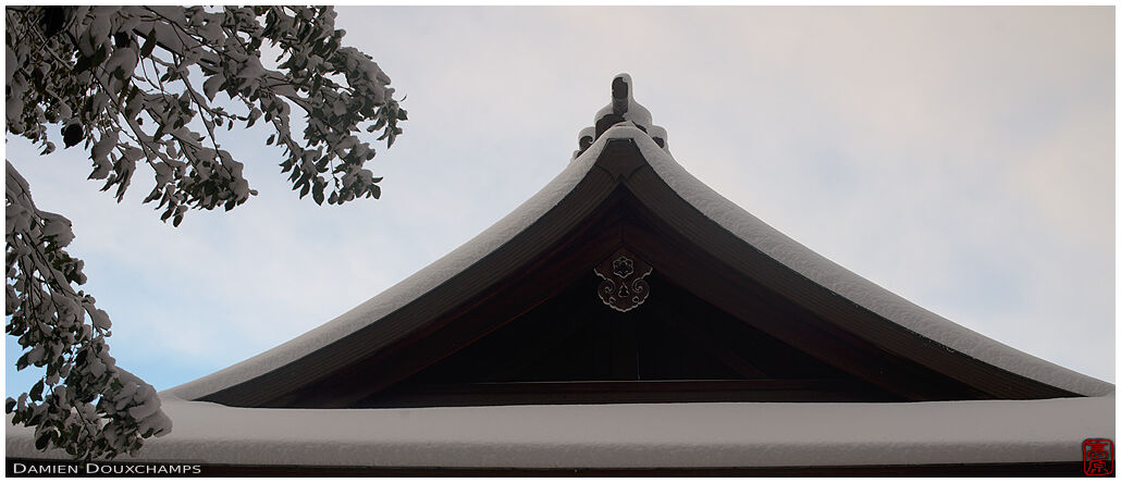Snow-covered roof line in Takenaka Inari shrine, Kyoto, Japan