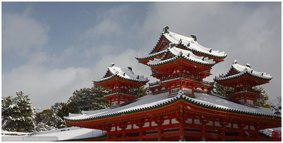 The snow covered and elaborate roofs of Heian-jingu shrine, Kyoto, Japan