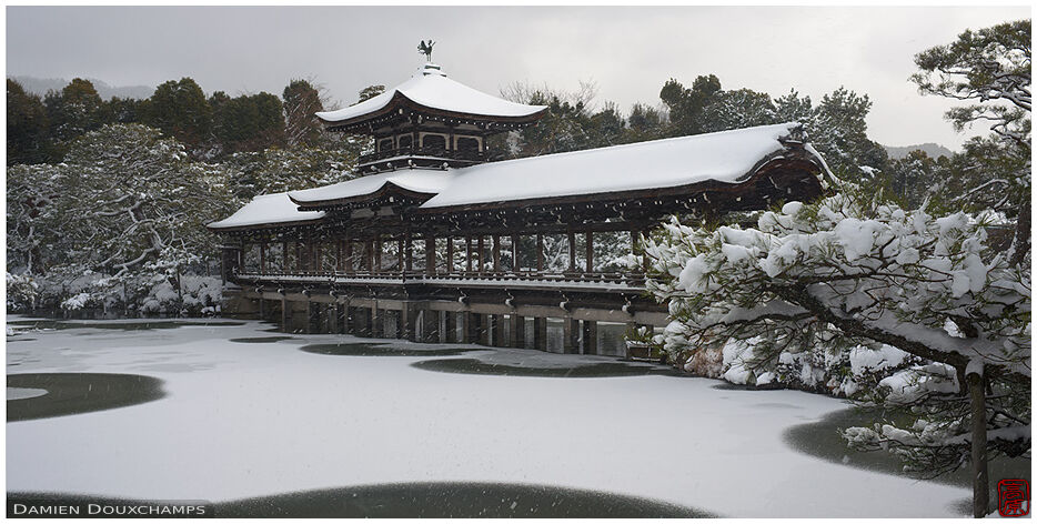 Snow-covered bridge on Heian shrine pond, Kyoto, Japan