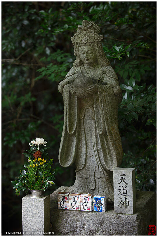 Stone statue with sake offerings, Shippo-ji temple, Osaka, Japan