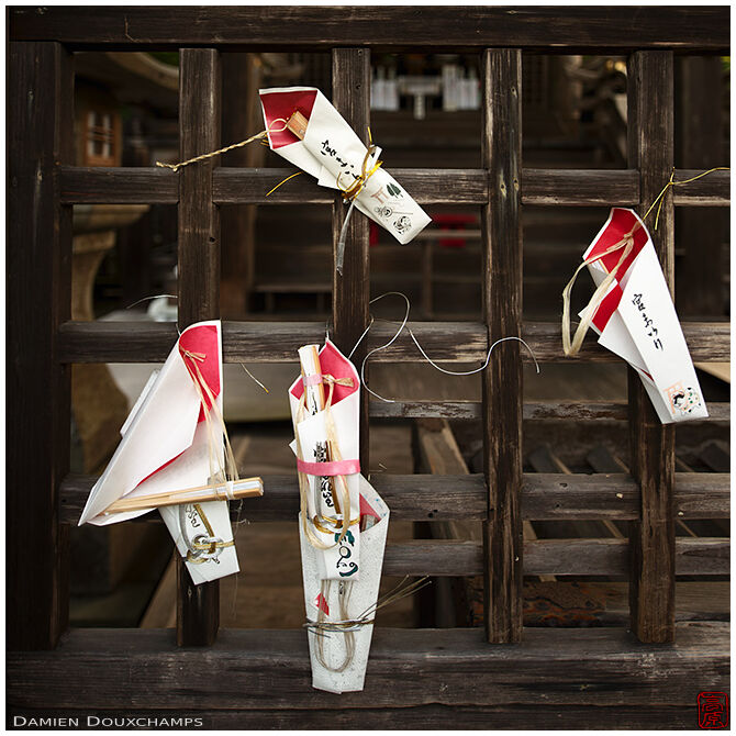 Votive offerings tied to a wooden fence, Kuwayama shrine, Kyoto, Japan