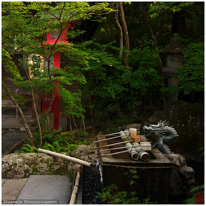 Ladles laid on a dragon fountain in Kuwayama shrine, Kyoto, Japan