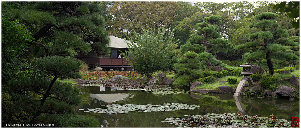 Stone lantern on the pond of Keitaku-en garden, Osaka, Japan