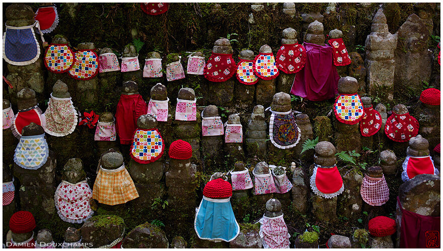 Collection of small jizo and gorinto grave stones with colorful bibs, Okuno-in forest cemetery, Koyasan, Japan
