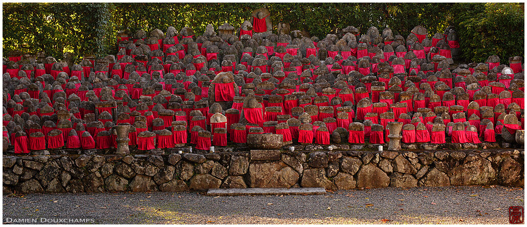 Afternoon light on the large gathering of jizo and their red bibs in Risho-in temple, Kyoto, Japan