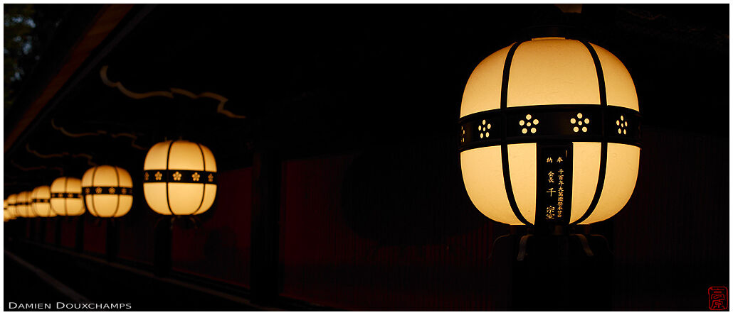 Row of lanterns at night, Kitano Tenmangu shrine, Kyoto, Japan