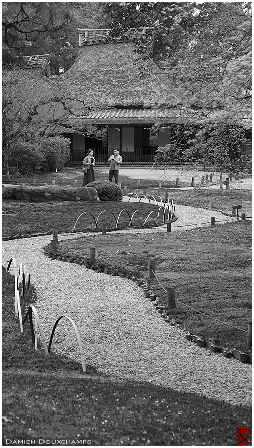 Winding path with visitors in Yoshiki-en gardens, Nara, Japan