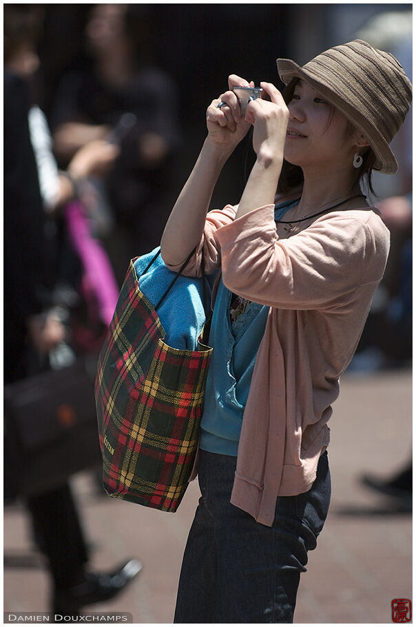 Fashionable girl with camera in Shibuya