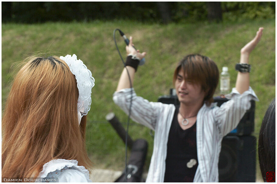 Maid listening to a rock concert in Osakajoo koen