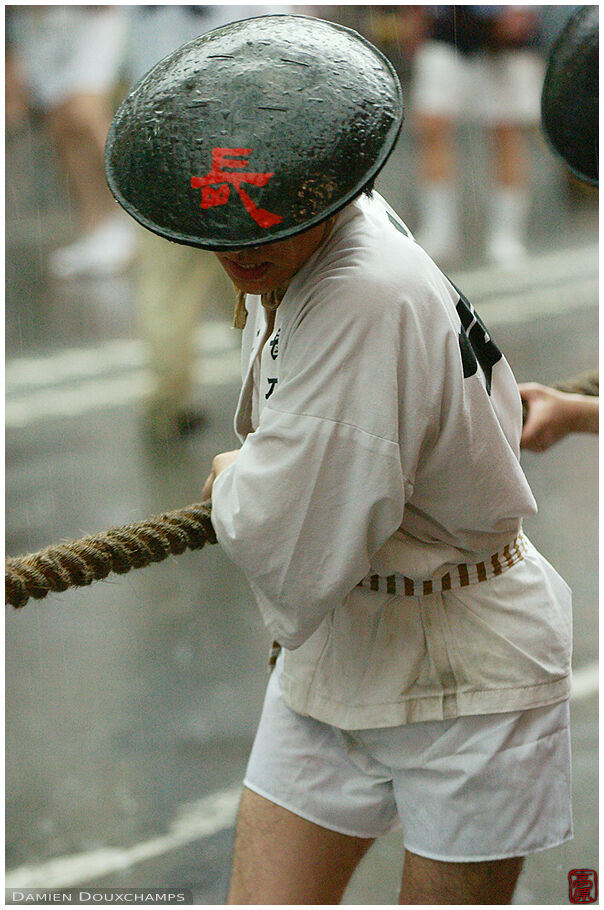 Pulling man with flat hat