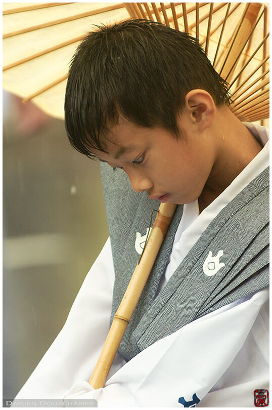 Kid with bamboo umbrella