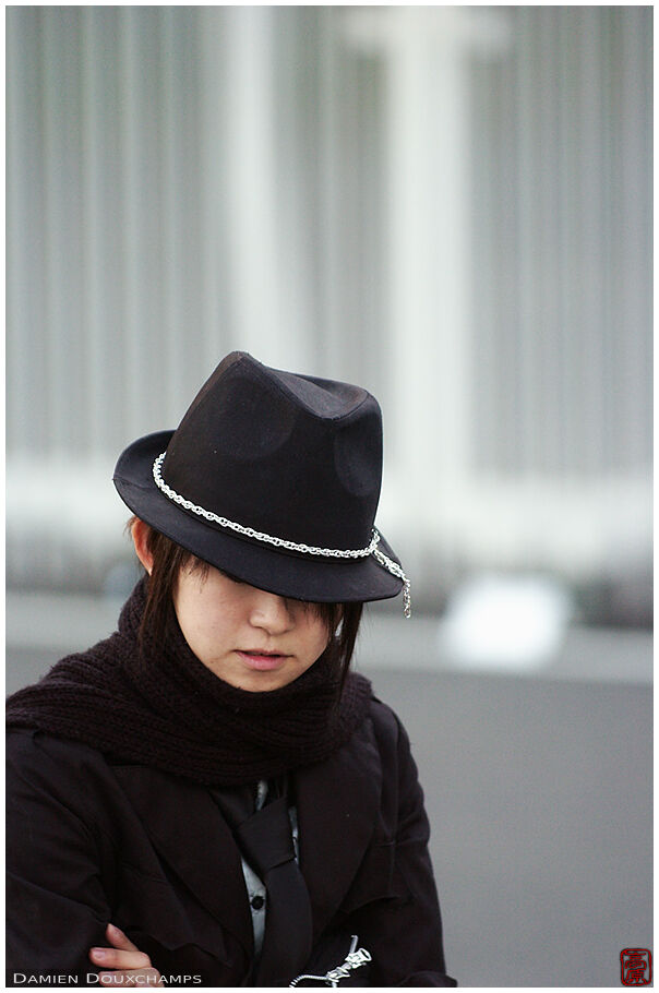 Girl with a black hat, hiding