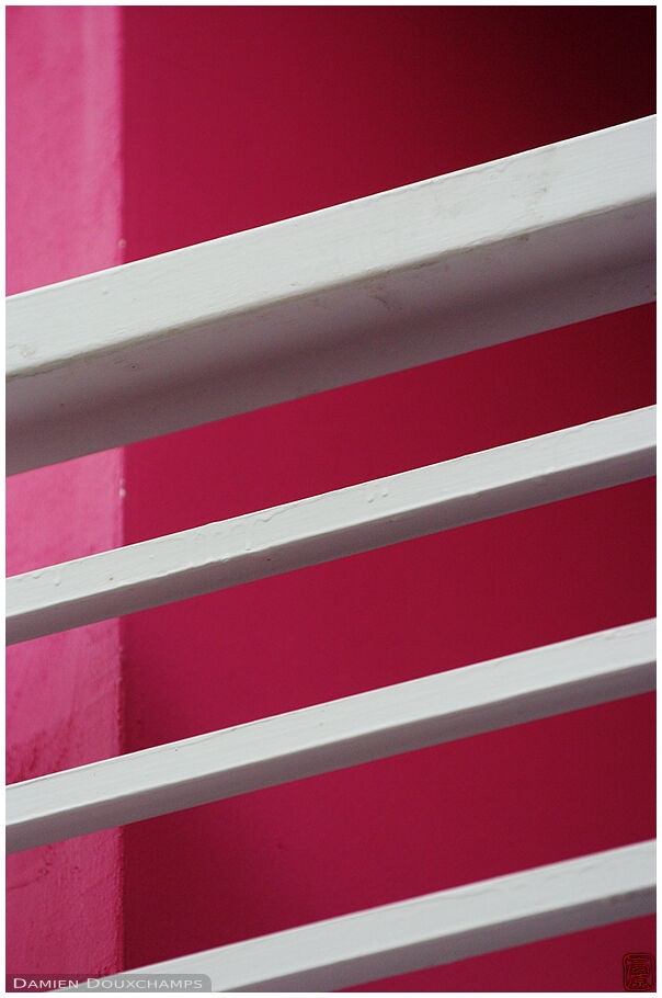 Pink wall and white staircase