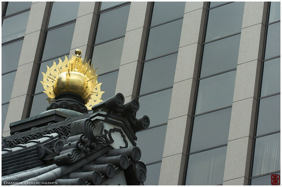 Temple roof detail and modern building