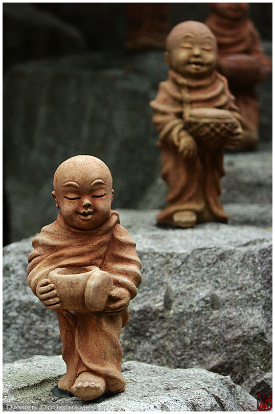 A queue of small monk statues