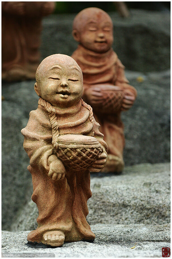 A queue of small monk statue, monochrome