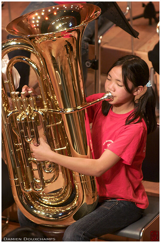 Kid playing the trombone during a jazz concert